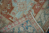 Hand-knotted foundation and distressed low pile of a vintage Persian Karaja rug corner.
