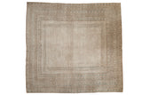 Distressed vintage Afghan carpet, faded ivory field, water channel, geometric borders.