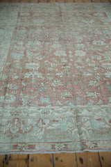 Distressed Malayer carpet border with floral cross-view and serrated leaves in dusty rose, pale green.