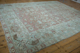 Distressed Malayer carpet border with pale seafoam green, dusty rose floral and serrated leaf motifs.