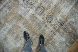Textural abrasions and visible foundation on a distressed camel Meshed carpet.