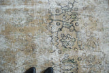 Distressed vintage Meshed rug with visible foundation, abrash, and faded floral motifs.
