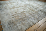 Distressed vintage Meshed carpet texture, showcasing camel and ivory tones with visible foundation.