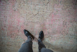 Faded pink and beige Meshed rug detail showing mostly even wear with faint foundation.