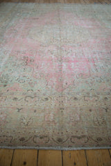 Vintage Distressed Meshed carpet showing worn texture, faded pink, ivory, and seafoam green.