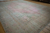 Mostly even wear across the distressed pink and ivory field, revealing subtle traditional motifs.