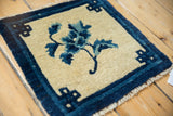 Indigo infinity knot border and partial floral on a vintage Chinese Peking rug.