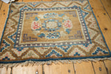 Vintage Ningxia rug corner: geometric guls, pearl border, distressed dusty bronze pile.