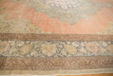 Faded pink and dusty blue floral pattern details on a distressed Turkish Kayseri rug.