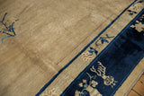Vintage Peking carpet, cobalt pictorial vase border and ivory field with floral sprays.