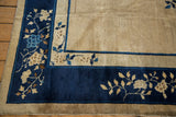 Vintage Peking carpet corner detail, showing cobalt blue border with beige floral branch sprays.