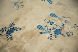 Pictorial vase motif and floral sprays on vintage Peking carpet in antique ivory and varied blue hues.