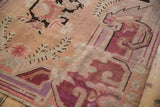 Distressed Vintage Khotan carpet border with curvilinear vines, faded burgundy, violet, and blush tones.