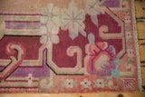 Distressed vintage Khotan rug border, showing curvilinear floral vines in blush and seafoam.