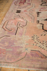 Distressed vintage Khotan rug, showing faded blush, pale violet, and evident low pile wear.