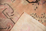 Distressed Khotan carpet pile with faded blush and violet, revealing hand knotted foundation.