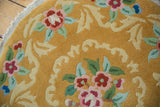 Art Deco rug with meandering leaf, dusty raspberry, and pale green floral bouquet patterns.