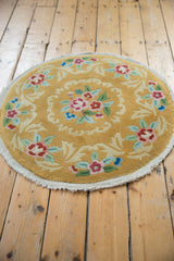 Meandering dusty raspberry and green florals on saffron yellow Art Deco rug fringe.