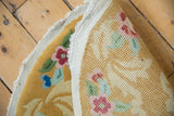 Close-up of the hand-knotted reverse of the Art Deco round rug, showing saffron and pastel tones.