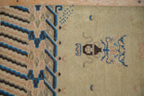 Close-up of antique Ningxia rug showing blue mountainous range and pearled border motifs.