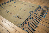 Detail of antique Ningxia pillar carpet showing cobalt blue cloudband design and germinating plants.