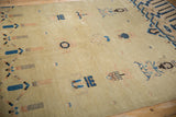 Individual blue, dusty rose, and brown germinating plant motifs on an antique Ningxia rug.