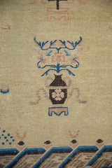 Antique Ningxia carpet detail: chocolate brown vase with peach and blue germinating plants.