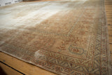Distressed vintage Sivas rug: dusty peach field with faded buds, visible foundation, and worn borders.