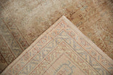 Folded corner of vintage Sivas carpet revealing distressed pile, visible foundation, and intricate reverse weave.