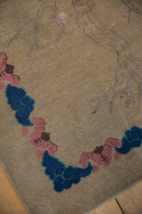 Antique Chinese Art Deco rug corner with cobalt blue clouds, blush cherry blossoms, and intact selvage.