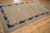 Antique Art Deco rug corner with faded cherry blossom and blue-pink cloud border.