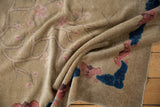 Varied pile of an antique Art Deco rug featuring blush cherry blossoms and bold cobalt blue motifs.
