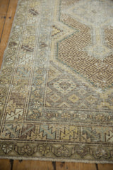 Intricate geometric patterns and visible pile wear on a vintage Hamadan runner.