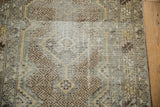 Worn texture on a vintage Hamadan runner showing geometric diamond relief and maze-like field.