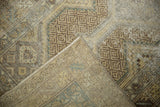 Folded vintage distressed Hamadan runner, showing geometric pattern and woven texture.