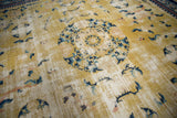 Saffron yellow field of antique Ningxia rug, cobalt blue florals, and visible foundation wear.