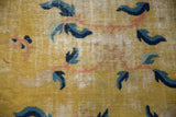 Antique Chinese Ningxia rug detail: Saffron field, blue-copper floral elements, foundation wear.