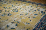 Worn saffron field detail of antique Ningxia rug with cobalt blue motifs and geometric border.