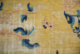 Saffron field of antique Ningxia carpet, visible foundation, blue and pale copper floral design.