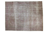 Vintage distressed Tabriz carpet with a faded floral medallion in dusty purple and antique ivory.