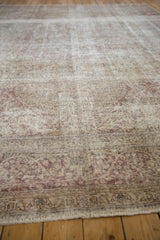 Low perspective on a distressed Tabriz carpet revealing its worn texture and foundation.