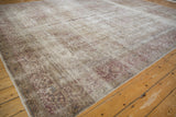 Time-softened texture of a distressed Persian Tabriz carpet with visible knot heads and foundation.