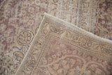 The hand-knotted back and restored side selvage of a vintage distressed Tabriz carpet.