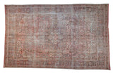 Vintage distressed Northwest Persian carpet with faded rose, brown, and ivory geometric design.