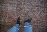 Distressed vintage Northwest Persian carpet with mostly even wear, faded rose and plum tones.