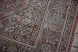 Muted rose and brown patterns with visible distressed pile on this vintage Northwest Persian carpet.