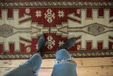 Distressed chestnut and ivory geometric pattern on a vintage Turkish Oushak rug runner.