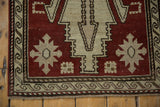 Distressed Oushak runner corner, chestnut field, wave border, and faint foundation.