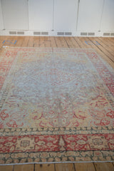 Distressed low pile and muted red floral patterns on a vintage Turkish Kayseri carpet.