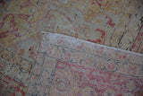 Distressed vintage Kayseri carpet with faded pile, visible foundation, and woven back fringe.